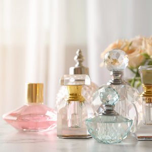 Many different perfume bottles on dressing table, space for text
